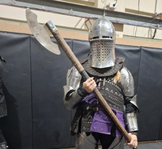 Australian buhurt fighter from Tyr’s Warriors holding a polearm in steel armour